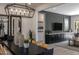 Elegant dining room with dark wood table and statement lighting at 33580 N Maverick Mountain Trl, San Tan Valley, AZ 85144