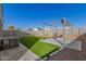 The backyard features a small, well-manicured lawn, paved patio, and pergola perfect for outdoor entertaining at 3481 N 309Th Ln, Buckeye, AZ 85396