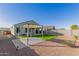 An immaculate backyard showcases artificial grass, a pergola, a paved patio, and thoughtfully landscaped areas at 3481 N 309Th Ln, Buckeye, AZ 85396