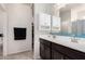 This bathroom has a double sink vanity with a decorative backsplash and white cabinets at 3481 N 309Th Ln, Buckeye, AZ 85396