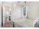 Bedroom with carpeted floors, a ceiling fan, and a window with sheer white curtains at 3481 N 309Th Ln, Buckeye, AZ 85396
