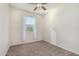 Bright bedroom with carpet, a ceiling fan, and a window with sheer white curtains at 3481 N 309Th Ln, Buckeye, AZ 85396