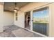 The covered patio has tiled flooring and a ceiling fan with views of the backyard at 3481 N 309Th Ln, Buckeye, AZ 85396