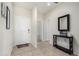 Inviting entryway with tiled floors, a black console table, and a white front door at 3481 N 309Th Ln, Buckeye, AZ 85396