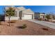 Single-story home featuring a two-car garage, desert landscaping, and a paved driveway at 3481 N 309Th Ln, Buckeye, AZ 85396