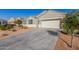 Single story home with a driveway and low-maintenance landscaping on a sunny day at 3481 N 309Th Ln, Buckeye, AZ 85396