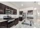 The kitchen features granite countertops, stainless steel appliances, gas range, dark cabinetry, and modern fixtures at 3481 N 309Th Ln, Buckeye, AZ 85396