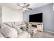 The living room features a neutral color palette, ceiling fan, comfortable seating, and entertainment center at 3481 N 309Th Ln, Buckeye, AZ 85396