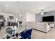 Inviting open-concept living space with a kitchen island, stainless appliances, breakfast nook, and comfortable seating area at 3481 N 309Th Ln, Buckeye, AZ 85396