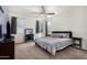 This spacious main bedroom has plush carpet, neutral decor, and two windows providing natural light at 3481 N 309Th Ln, Buckeye, AZ 85396