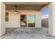 Covered patio boasts a ceiling fan and sliding glass doors that lead to the home's interior at 3481 N 309Th Ln, Buckeye, AZ 85396