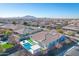 Aerial view of a house with a pool and landscaped backyard in a residential neighborhood at 3728 E Mia Ln, Gilbert, AZ 85298