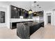 Sleek kitchen island with marble countertop and black cabinetry at 3728 E Mia Ln, Gilbert, AZ 85298