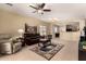 Comfortable living room featuring a leather couch and access to the patio at 3836 N Hidden Canyon Dr, Florence, AZ 85132