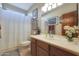 Clean bathroom with wood vanity, shower, and updated fixtures at 4808 N Litchfield E Knl, Litchfield Park, AZ 85340