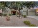 Desert landscaping surrounds this charming stucco home with a three-car garage at 4808 N Litchfield E Knl, Litchfield Park, AZ 85340