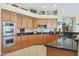 Spacious kitchen featuring granite countertops and oak cabinetry at 4808 N Litchfield E Knl, Litchfield Park, AZ 85340