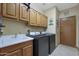 Laundry room with washer, dryer, and built-in cabinets at 4808 N Litchfield E Knl, Litchfield Park, AZ 85340