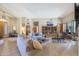 Open living room with hardwood floors, comfortable seating, and built-in shelves at 4808 N Litchfield E Knl, Litchfield Park, AZ 85340