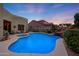 Swimming pool and spa with waterfall feature at sunset at 4808 N Litchfield E Knl, Litchfield Park, AZ 85340