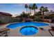 Swimming pool and spa with waterfall feature at dusk at 4808 N Litchfield E Knl, Litchfield Park, AZ 85340