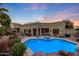 Swimming pool and spa with surrounding patio and landscaping at 4808 N Litchfield E Knl, Litchfield Park, AZ 85340