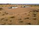 Aerial view of a house on a large lot with a chain link fence at 53929 W Bowlin Rd, Maricopa, AZ 85139