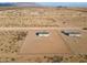 Aerial view of a house on a large lot with a chain link fence at 53929 W Bowlin Rd, Maricopa, AZ 85139