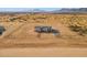 Aerial view of a house on a large lot with a chain link fence at 53929 W Bowlin Rd, Maricopa, AZ 85139