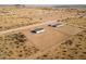 Aerial view of a house on a large lot with a chain link fence at 53929 W Bowlin Rd, Maricopa, AZ 85139
