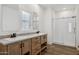 Bathroom with double vanity, large mirror, and glass shower at 53929 W Bowlin Rd, Maricopa, AZ 85139