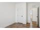 Light and airy bedroom with wood-look floors and access to a bathroom at 53929 W Bowlin Rd, Maricopa, AZ 85139