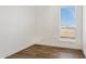 Bright bedroom with wood-look floors and large window at 53929 W Bowlin Rd, Maricopa, AZ 85139