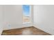 Bedroom with wood-look floors and a window with blinds at 53929 W Bowlin Rd, Maricopa, AZ 85139