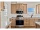 Modern kitchen with stainless steel range and light wood cabinets at 53929 W Bowlin Rd, Maricopa, AZ 85139