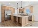 Modern kitchen with stainless steel appliances and light wood cabinets at 53929 W Bowlin Rd, Maricopa, AZ 85139