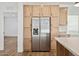 Stainless steel refrigerator with light wood cabinets at 53929 W Bowlin Rd, Maricopa, AZ 85139