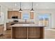 Modern kitchen with island, stainless steel appliances, and wood cabinets at 53929 W Bowlin Rd, Maricopa, AZ 85139