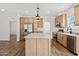 Modern kitchen with stainless steel appliances and light wood cabinets at 53929 W Bowlin Rd, Maricopa, AZ 85139