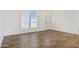 Simple living room with wood floors and window at 53929 W Bowlin Rd, Maricopa, AZ 85139