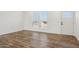Bright living room with wood floors and large windows at 53929 W Bowlin Rd, Maricopa, AZ 85139