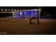 Night view of mobile home with covered porch, fenced yard, fire pit, and string lights at 54160 W Barnes Rd, Maricopa, AZ 85139