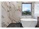 Spa-like bathroom with soaking tub, walk-in shower, and marble tile at 6216 W Molly Dr, Phoenix, AZ 85083