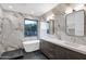Modern bathroom with marble tile, double vanity and freestanding tub at 6216 W Molly Dr, Phoenix, AZ 85083