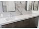 Modern double vanity with dark brown cabinets and white countertop at 6216 W Molly Dr, Phoenix, AZ 85083