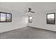 Bright bedroom with grey carpet, ceiling fan and multiple windows at 6216 W Molly Dr, Phoenix, AZ 85083