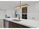Modern kitchen island with sink, dishwasher, and stylish pendant lighting at 6216 W Molly Dr, Phoenix, AZ 85083