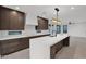 Modern kitchen with island, stainless steel appliances, and dark wood cabinets at 6216 W Molly Dr, Phoenix, AZ 85083