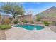 Inviting kidney-shaped pool with stone patio at 6216 W Molly Dr, Phoenix, AZ 85083