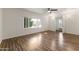 Bright bedroom with wood-look floors, large window, and ceiling fan at 6547 N 3Rd Ave, Phoenix, AZ 85013